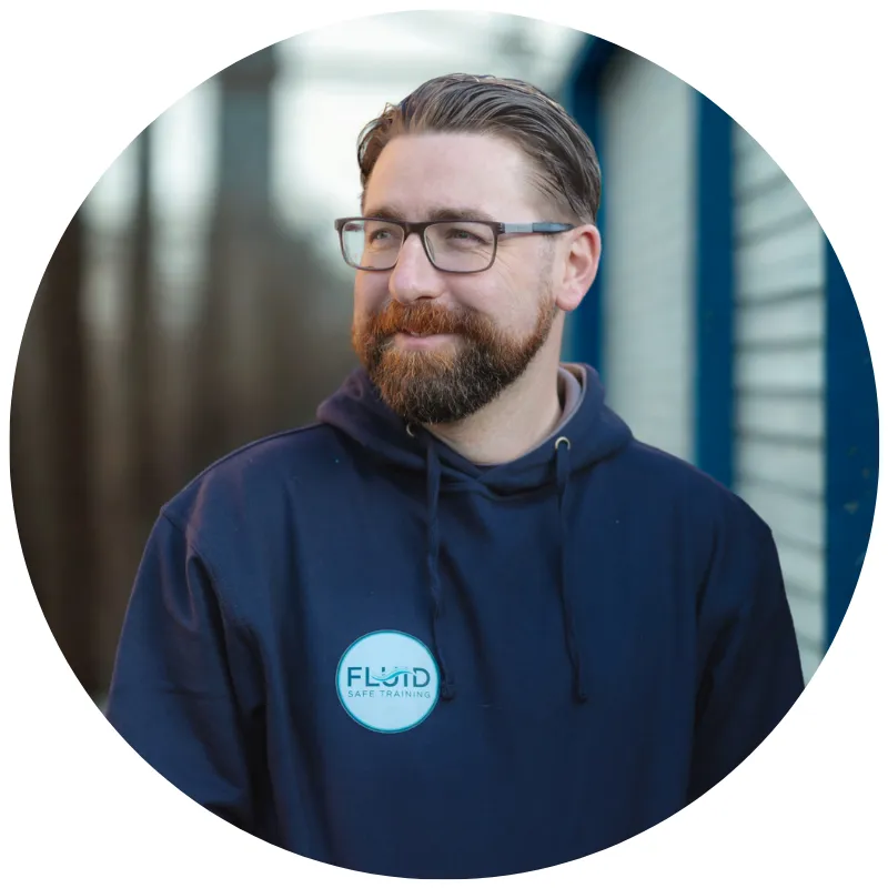 Robbie Jones, Fluid Safe Training's lead consultant, wearing a navy hoodie with the company logo.